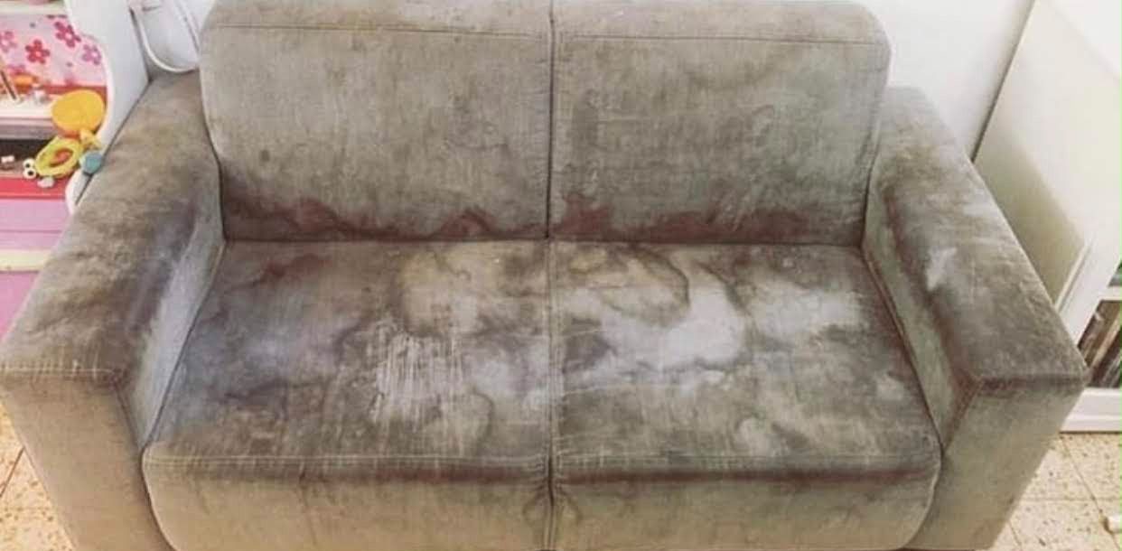 Fabric sofa before cleaning, heavily stained cushions